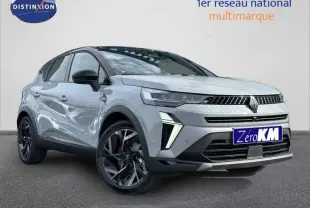 Renault Captur 1.8 E-Tech hybride 2026 en gris Rafale et noir, vue 3/4 avant avec jantes noires distinctives.