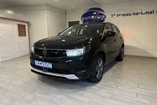 Opel Grandland noir en 3/4 avant droit, intérieur showroom avec plaque "OCCASION" visible à l'avant.