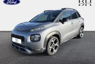 Citroën C3 Aircross gris acier vue 3/4 avant droit avec barres de toit et jantes diamantées 17 pouces.