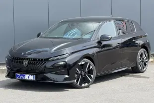 Peugeot 308 NV Hybrid 145 GT noir Perla, vue 3/4 avant droit, jantes alliage bi-tons et calandre distinctive.