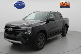 Ford Ranger Wildtrak noir vu en 3/4 avant droit, avec barres de toit, marchepieds et jantes alliage 18 pouces.