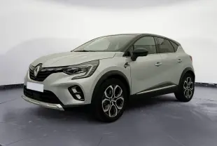 Renault Captur E-Tech hybride 2023 gris alu/noir en 3/4 avant droit, avec jantes alliage et toit noir contrasté.