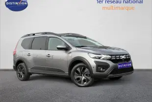 Vue 3/4 avant droit du Dacia Jogger gris schiste métallisé, version 7 places avec détails noirs contrastants.