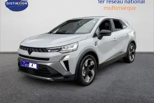 Renault Symbioz gris Rafale métal en 3/4 avant droit, avec calandre noire et jantes stylisées bicolores.