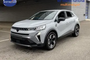 Renault Symbioz gris Rafale métal en 3/4 avant droit, SUV hybride avec calandre noire et jantes bicolores modernes.