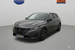 Peugeot 308 gris en 3/4 avant droit, avec calandre noire distinctive et phares LED fins dans un studio.