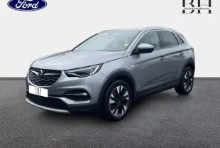 Opel Grandland X gris Quartz vu en 3/4 avant droit avec toit et rétroviseurs noirs sur fond neutre.