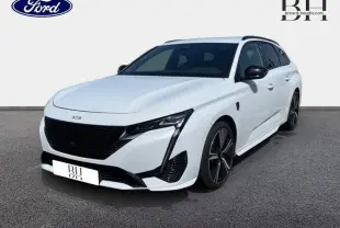 Peugeot 308 SW PHEV blanc Okénite vue 3/4 avant droit avec jantes alu noires et calandre noire distinctive