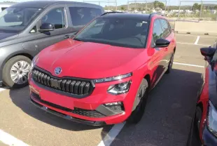 Vue 3/4 avant droite d'un Skoda Kamiq Monte-Carlo rouge Velvet avec toit panoramique et jantes alliage noires.