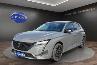 Peugeot 308 Hybrid gris foncé vue 3/4 avant droite, avec calandre noire et phares LED distinctifs.