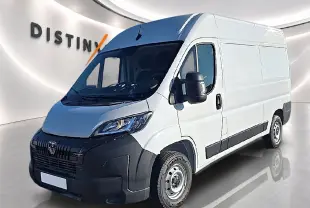 Vue 3/4 avant droit d'un Peugeot Boxer Fourgon blanc avec porte latérale coulissante et pare-chocs noirs.