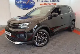 Citroën C5 Aircross noir en 3/4 avant droit, avec jantes distinctives et calandre moderne dans un showroom.
