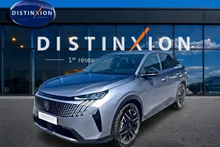 Peugeot 3008 gris en 3/4 avant droit, avec calandre distinctive et jantes alliage noires devant showroom Distinxion.