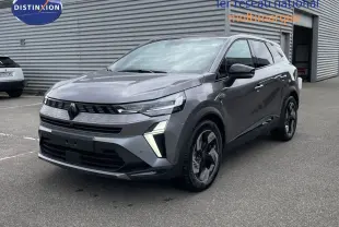 Renault Symbioz gris cassiopée métal en 3/4 avant droit, avec signature lumineuse LED distinctive et jantes stylisées.