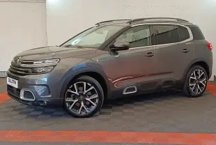 Citroën C5 Aircross Hybrid gris foncé en vue profil côté gauche, avec jantes alliage et barres de toit chromées.