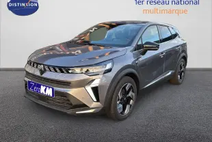 Renault Symbioz gris cassiopée métal en 3/4 avant droit, SUV hybride avec calandre moderne et jantes bicolores.
