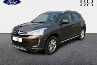 Citroën C4 Aircross brun Mangaro vue 3/4 avant droit avec calandre chromée et barres de toit visibles.
