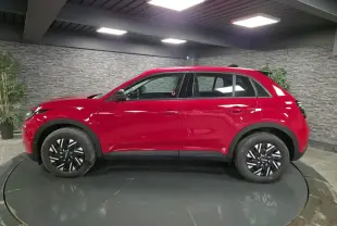 Vue de profil côté gauche d'une FIAT 600 rouge 2024 avec jantes acier bicolores et coques de rétroviseurs noires.