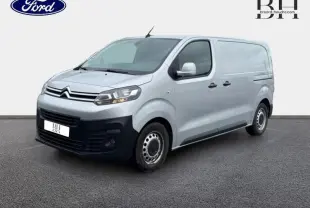 Vue 3/4 avant droit d'un Citroën Jumpy gris aluminium avec double portes latérales et pare-chocs noirs.