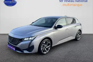 Peugeot 308 gris Artense vue 3/4 avant droit avec jantes alliage et calandre noire distinctive.