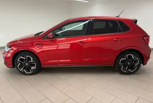 Vue de profil côté gauche d'une Volkswagen Polo 2025 Rouge Roi métallisée avec jantes R-Line distinctives.