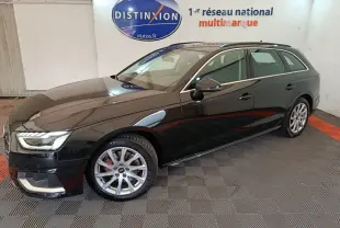 Audi A4 35 TFSI Business Line noire vue de profil droit en stationnement intérieur sur sol damier.