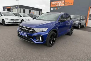 Volkswagen T-Roc Bleu Lapiz en 3/4 avant droit avec jantes noires et calandre R-Line visible sur parking.