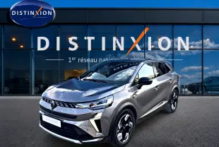Renault Symbioz gris 3/4 avant droit, SUV hybride avec calandre moderne et jantes bicolores distinctives.