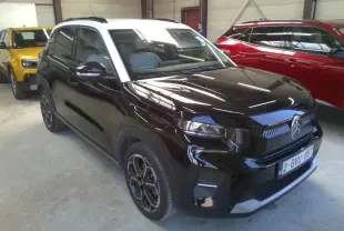 Citroën C3 1.2 Turbo 100ch Max noir perla avec toit blanc, vue 3/4 avant droit sur parking blanc.