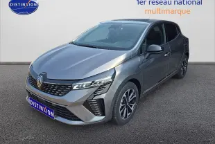 Renault Clio V gris schiste vue 3/4 avant droit, mettant en valeur sa calandre chromée et ses phares LED distinctifs.