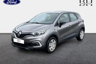 Renault Captur Gris Cassiopée en 3/4 avant droit, avec jantes acier et détails noirs sur les rétroviseurs.