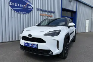 Toyota Yaris Cross blanc vue 3/4 avant droit, avec calandre noire et jantes bi-ton noires visibles.
