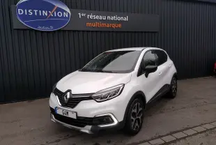 Renault Captur blanc en 3/4 avant droit, avec signature lumineuse LED et jantes alliage noires et argentées.