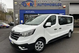 Renault Trafic Combi blanc glacier vu en 3/4 avant droit, porte latérale coulissante et vitres arrière visibles.
