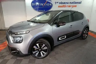 Citroën C3 gris foncé vue 3/4 avant droit avec protections latérales noires et jantes bicolores.