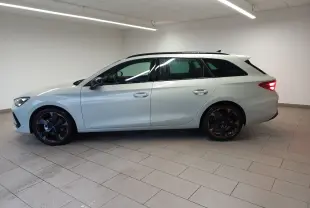 Vue de profil côté gauche d'une CUPRA LEON ST 1.5 eTSI 150 DSG7 gris Taiga avec jantes alliage 18'' cuivrées.