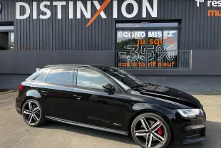 Audi S3 Sportback noir vue de profil côté gauche, avec jantes alliage et étriers de frein rouges visibles.