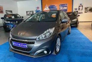 Peugeot 208 gris platinium vue 3/4 avant droit en showroom avec logo Distinxion sur la plaque avant.