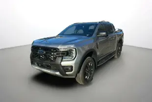 Ford Ranger 2.0 Wildtrak Plus gris iconic en 3/4 avant droit avec barres de toit et jantes alu noires.