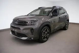 Citroën C5 Aircross Hybrid gris Platinium vue 3/4 avant droit avec jantes alliage bi-ton et barres de toit noires.