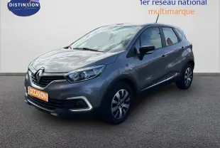 Renault Captur gris cassiopée en 3/4 avant droit, avec feux LED et jantes alliage bicolores visibles.