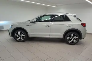 Vue de profil côté gauche du Volkswagen T-Roc 1.5 TSI R-Line 2024 en gris Ascot avec jantes alliage distinctives.
