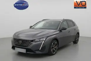 Peugeot 308 Hybrid gris vue 3/4 avant droit, avec calandre noire distinctive et jantes alliage 17 pouces.