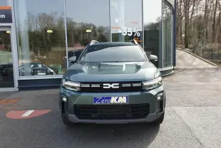 Vue de face du Dacia Bigster vert cèdre avec toit panoramique et signature lumineuse LED visible.