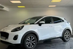 Vue 3/4 avant droite d'un Ford Puma blanc Glacier avec jantes noires et vitres arrière surteintées.