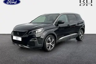 Peugeot 5008 noir Perla Nera vue 3/4 avant droit, avec jantes alliage et barres de toit visibles.
