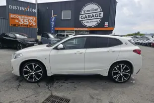BMW X2 sDrive 18d blanc vue de profil côté gauche avec jantes M Sport noires à rayons doubles.