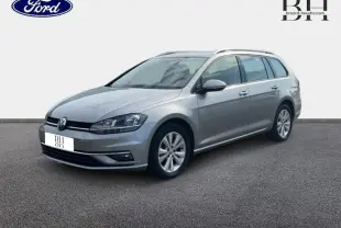 Volkswagen Golf SW gris Tungsten vue 3/4 avant droit, avec jantes alu et barres de toit visibles.
