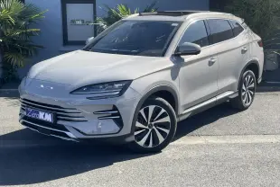 Vue 3/4 avant droite du SUV BYD SEAL U 2025 en beige métallisé Boundless Cloud avec jantes bicolores et barres de toit.