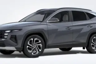 Hyundai Tucson 2025 gris Ecotronic en 3/4 avant droit, avec jantes alliage 19” et phares LED Matrix visibles.